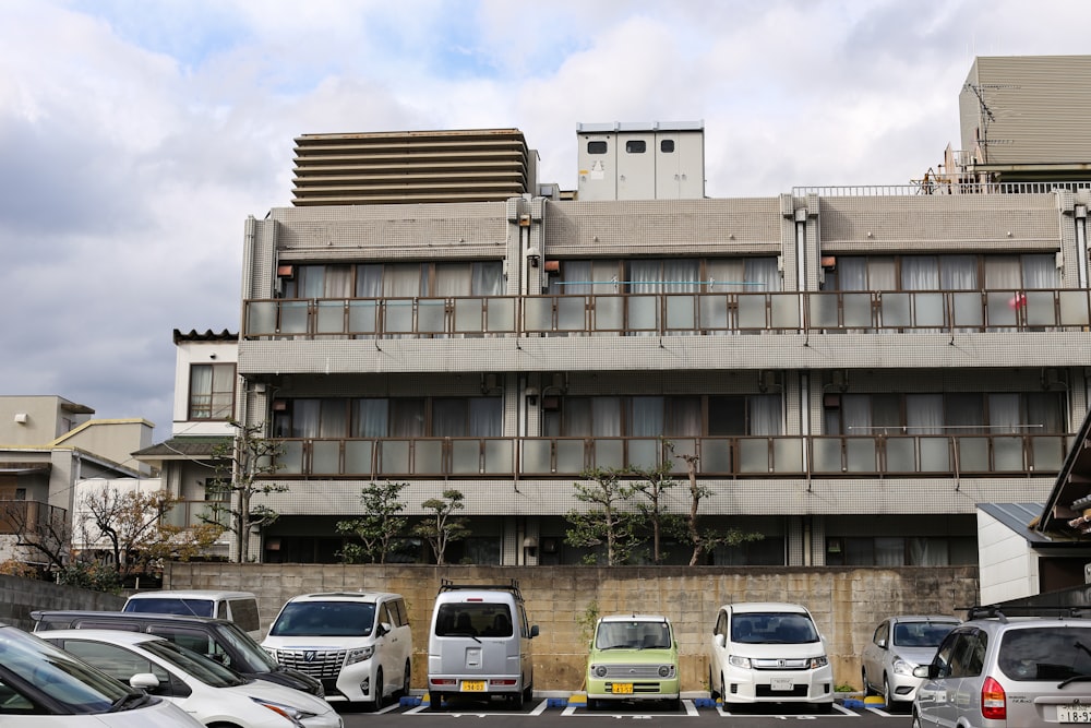 a parking lot with cars parked in front of a building