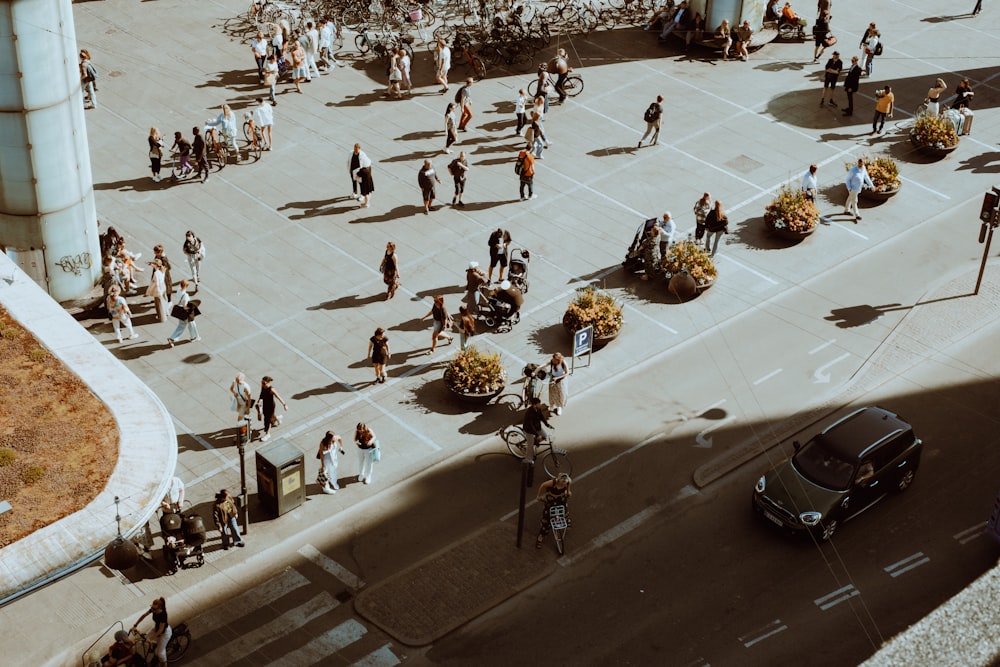 a crowd of people walking around a parking lot