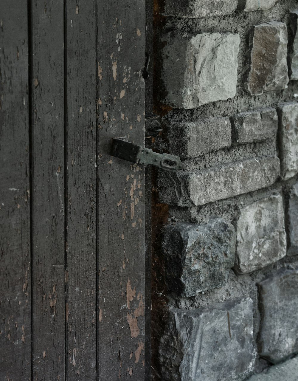 Un primo piano di una porta con un muro di mattoni sullo sfondo