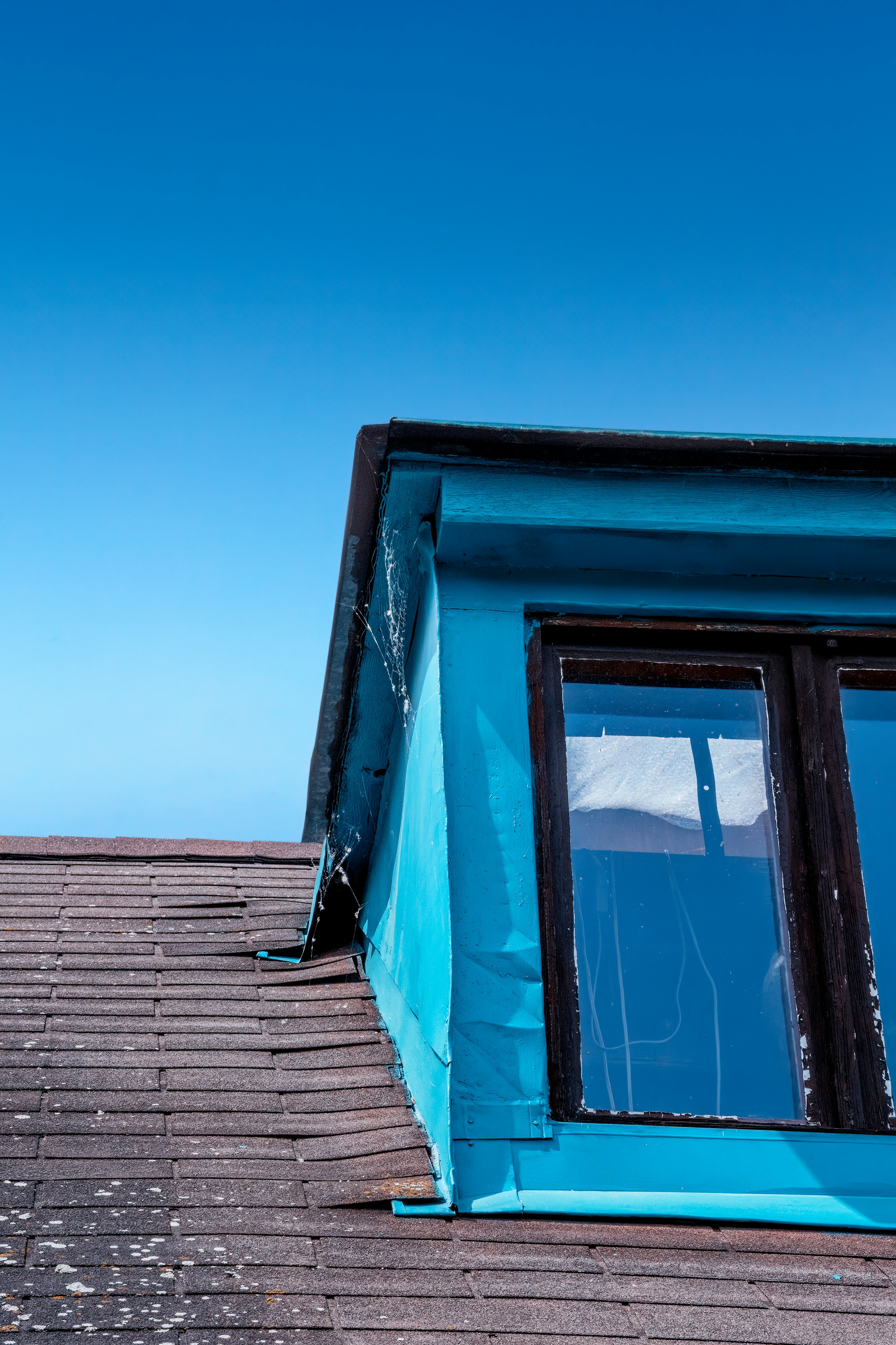 a view of the roof of a building with a blue sky in the background