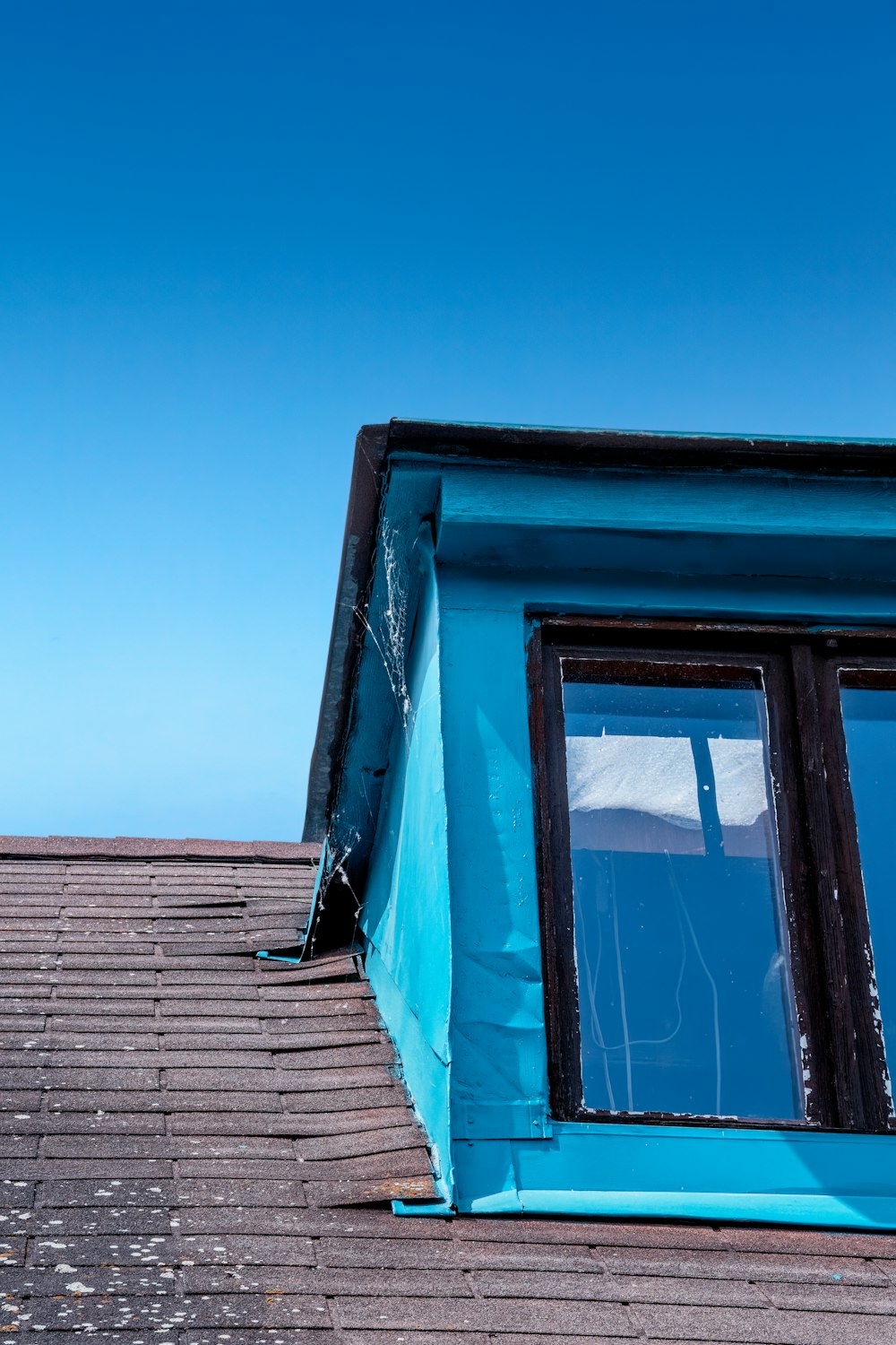 a view of the roof of a building with a blue sky in the background