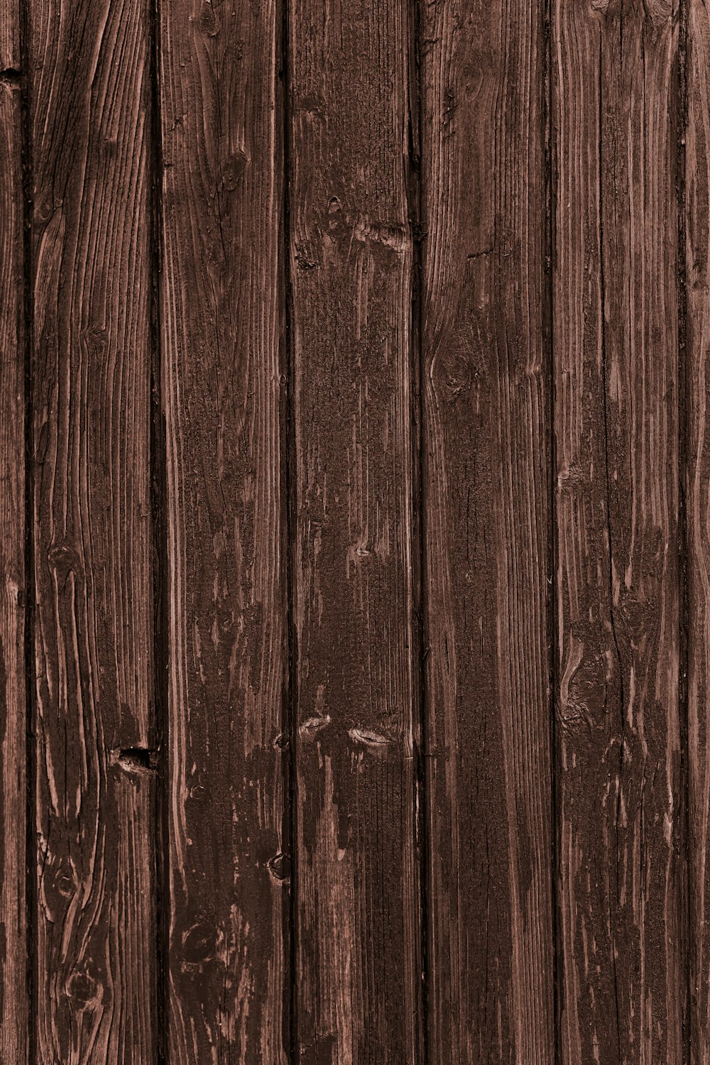 a close up of a wooden fence with a clock on it