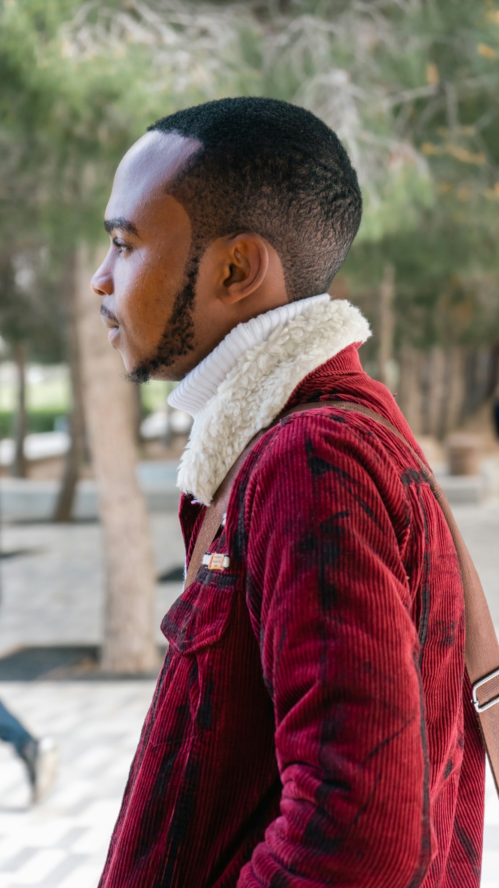 a man with a red jacket and a white scarf around his neck