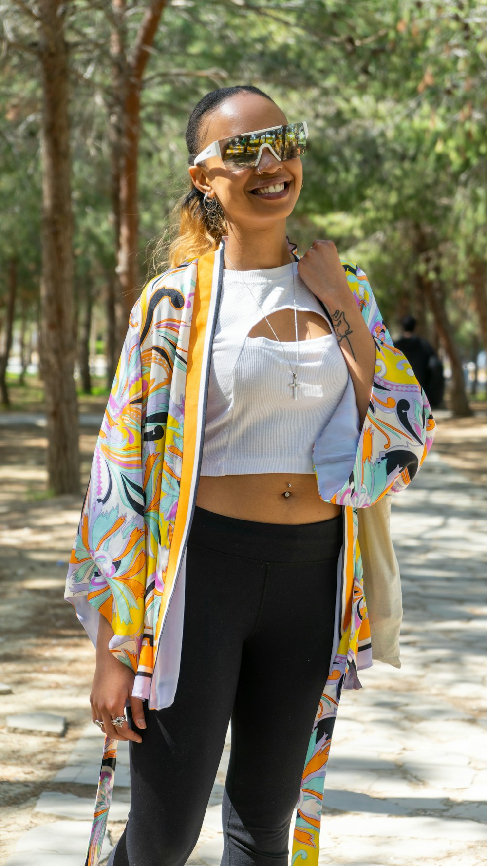 a woman in a white top and black leggings