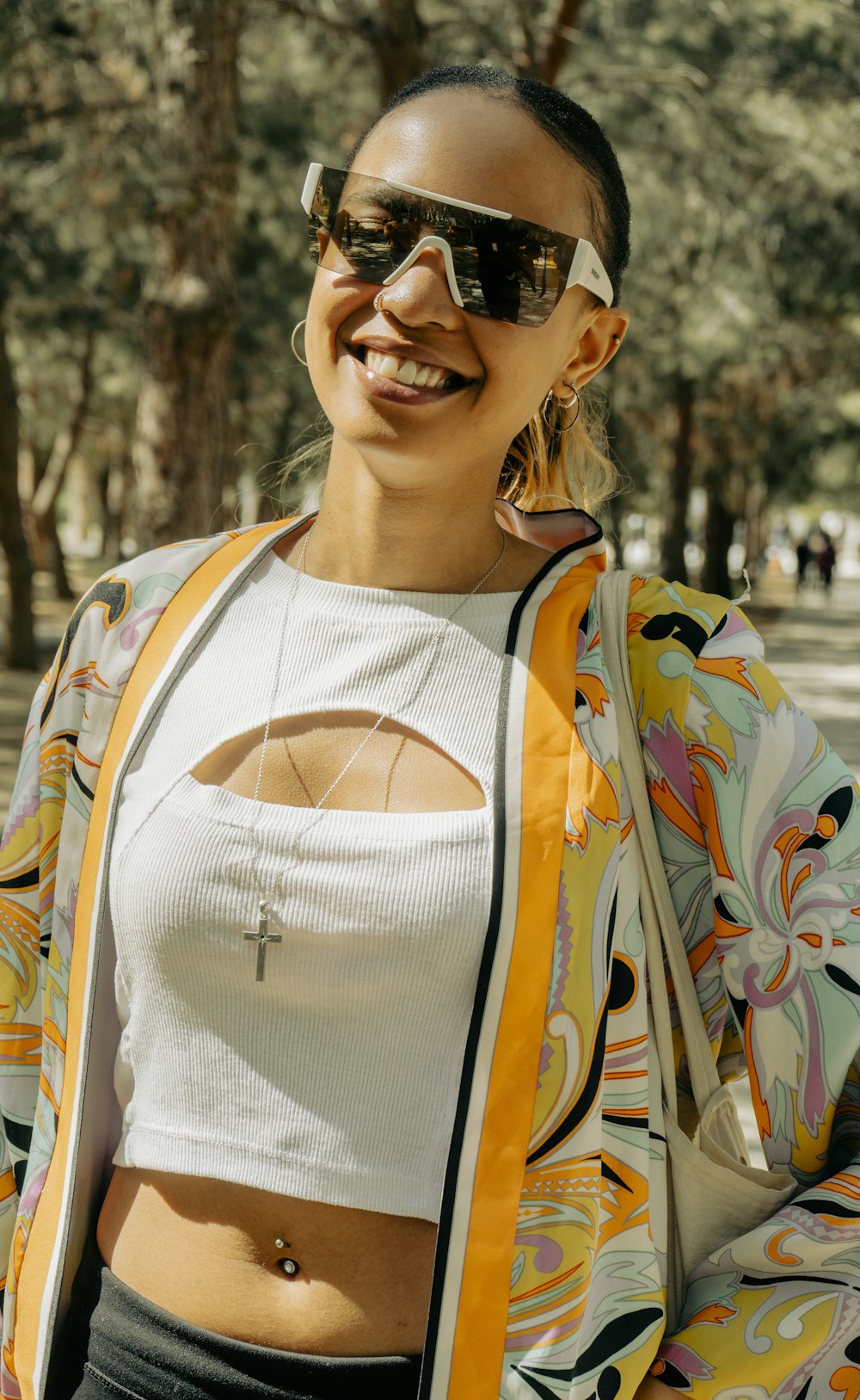 a woman wearing sunglasses and a colorful jacket