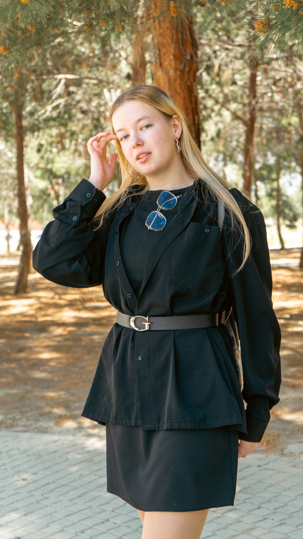 a woman in a black dress posing for a picture