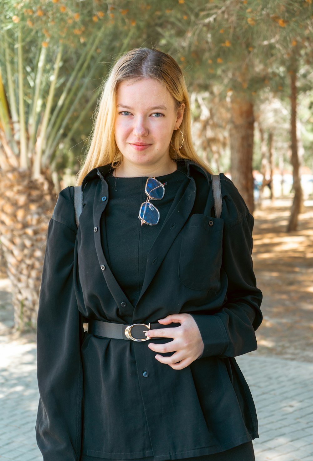 a woman standing in front of a tree