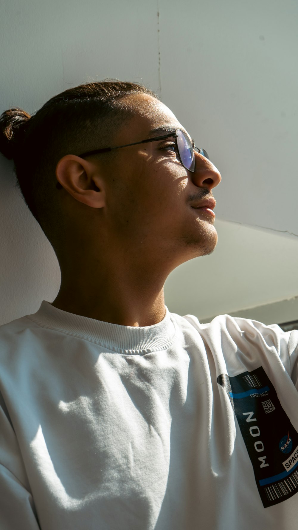 a man wearing a white shirt and sunglasses