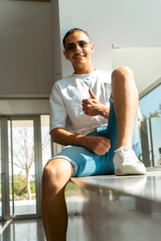A smiling customer giving a thumbs up in a cozy office setting.