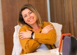 A smiling business owner using a tablet for customer engagement.
