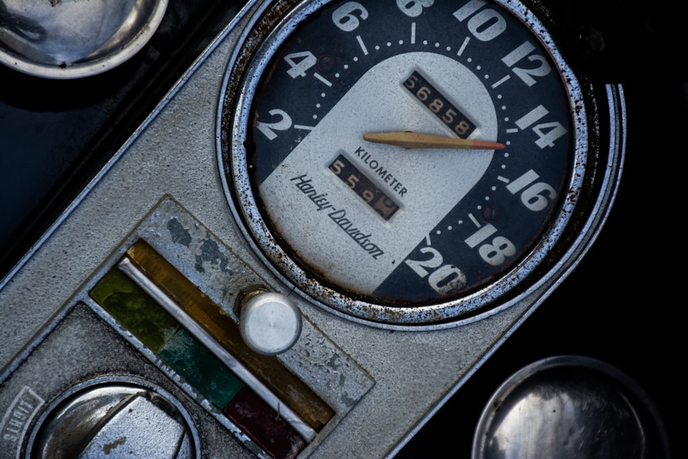 a close up of a clock on a car
