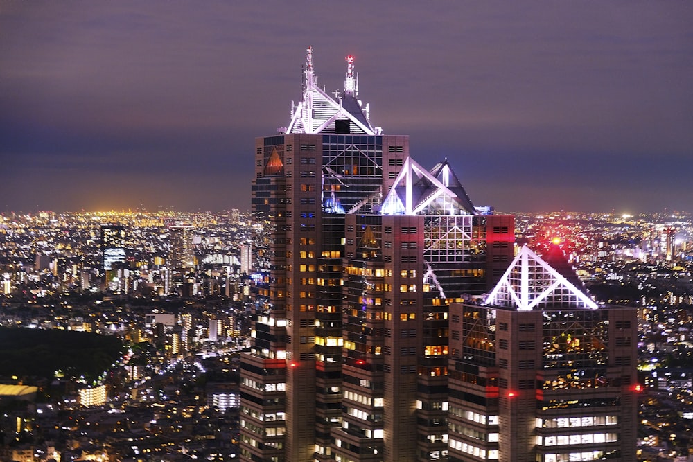 a view of a city at night from the top of a skyscraper