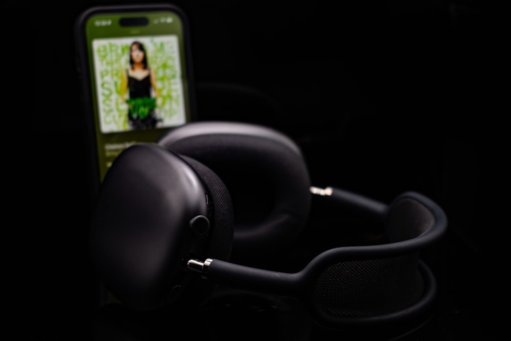 a pair of headphones sitting next to a cell phone