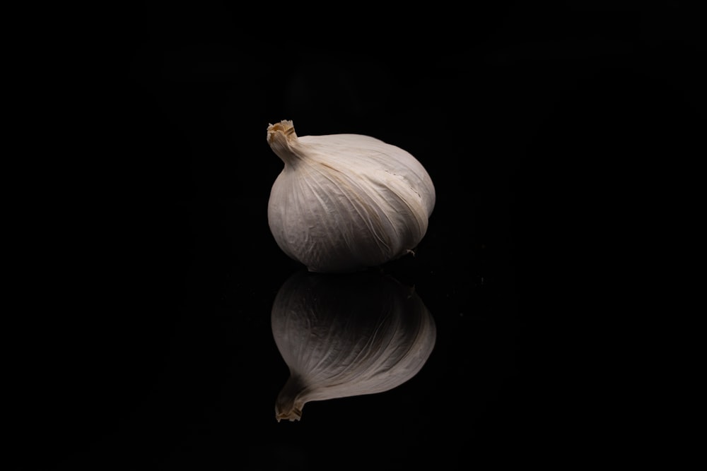 a close up of a garlic on a black background