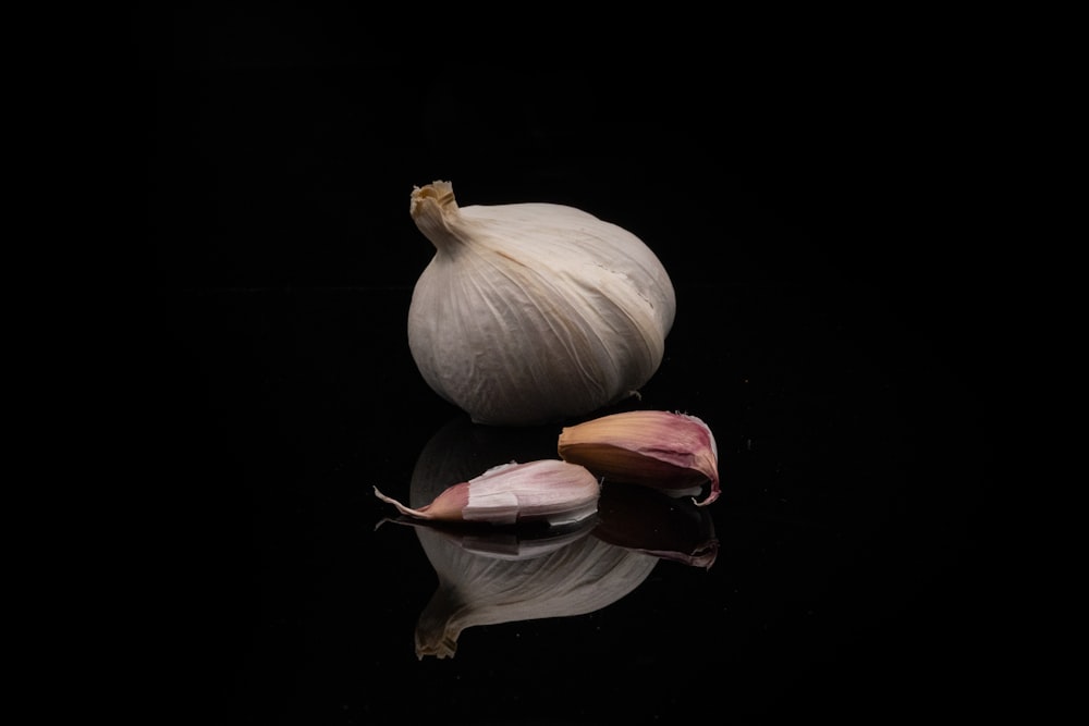 a close up of a garlic on a black background