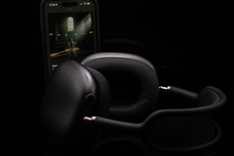 a pair of headphones sitting next to a cell phone