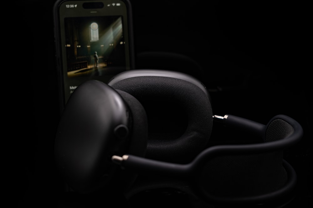 a pair of headphones sitting next to a cell phone