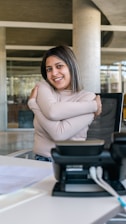 Smiling client consulting with an insurance broker in a modern office environment.