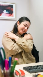 a woman sitting at a desk with her arms crossed