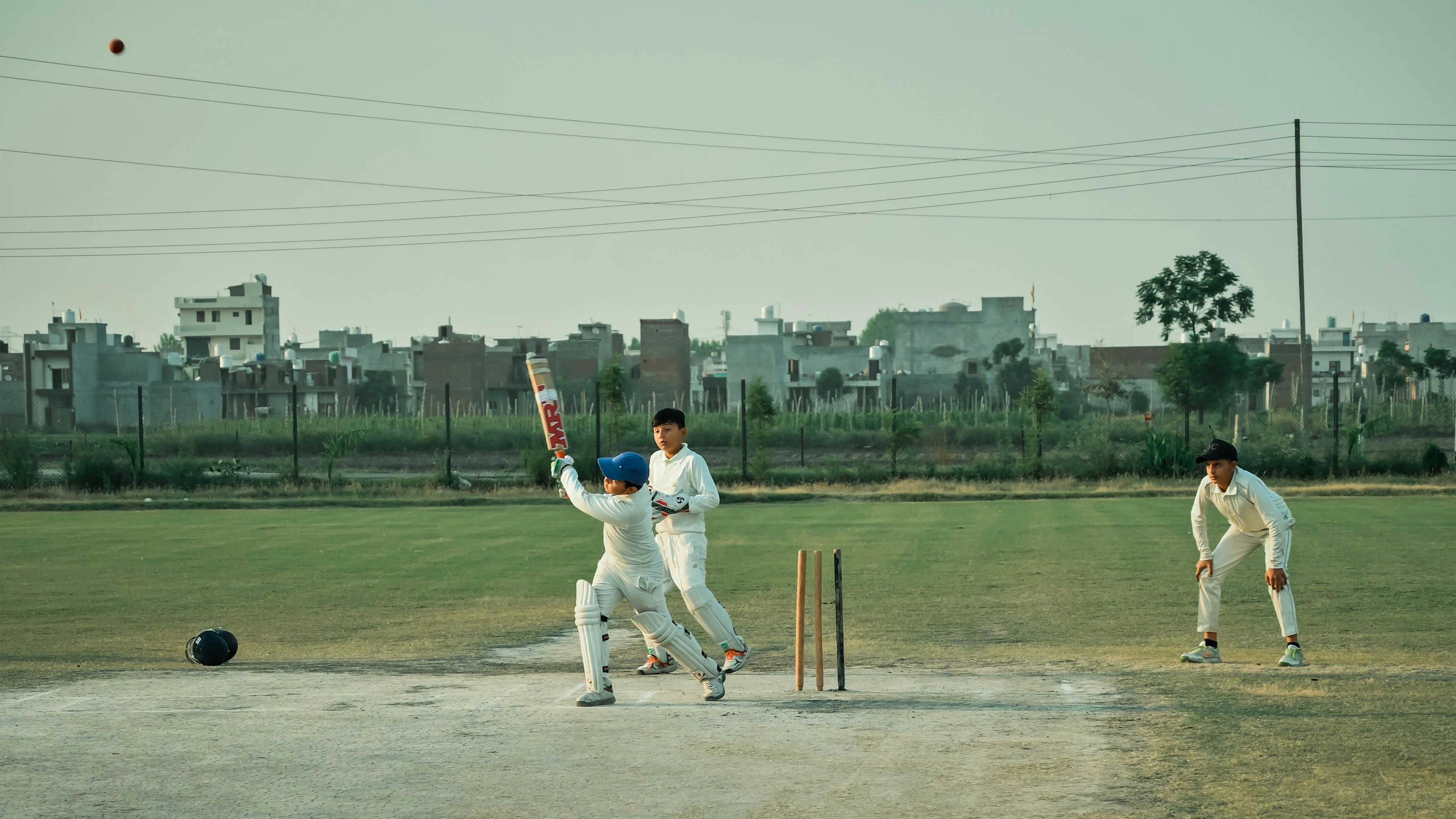 a group of men playing a game of cricket