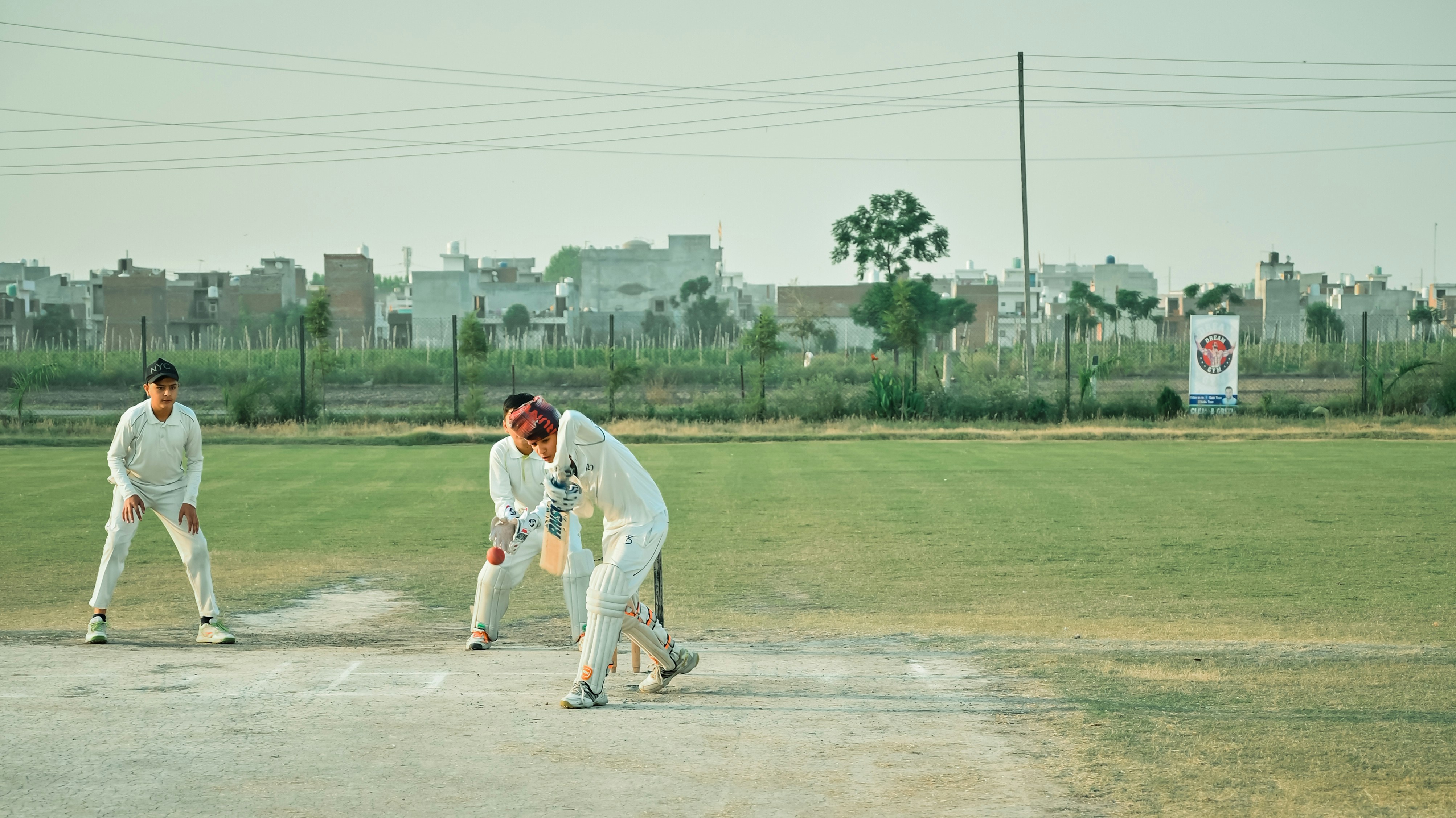 a group of men playing a game of cricket