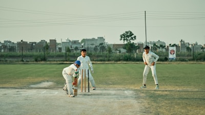a group of young men playing a game of cricket