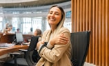 a woman sitting at a desk with her arms crossed