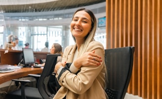 a woman sitting at a desk with her arms crossed