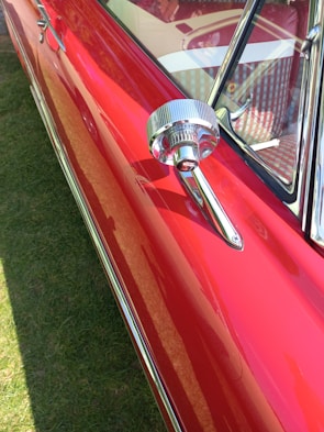 Side view of a shiny, restored car exterior sparkling under sunlight.