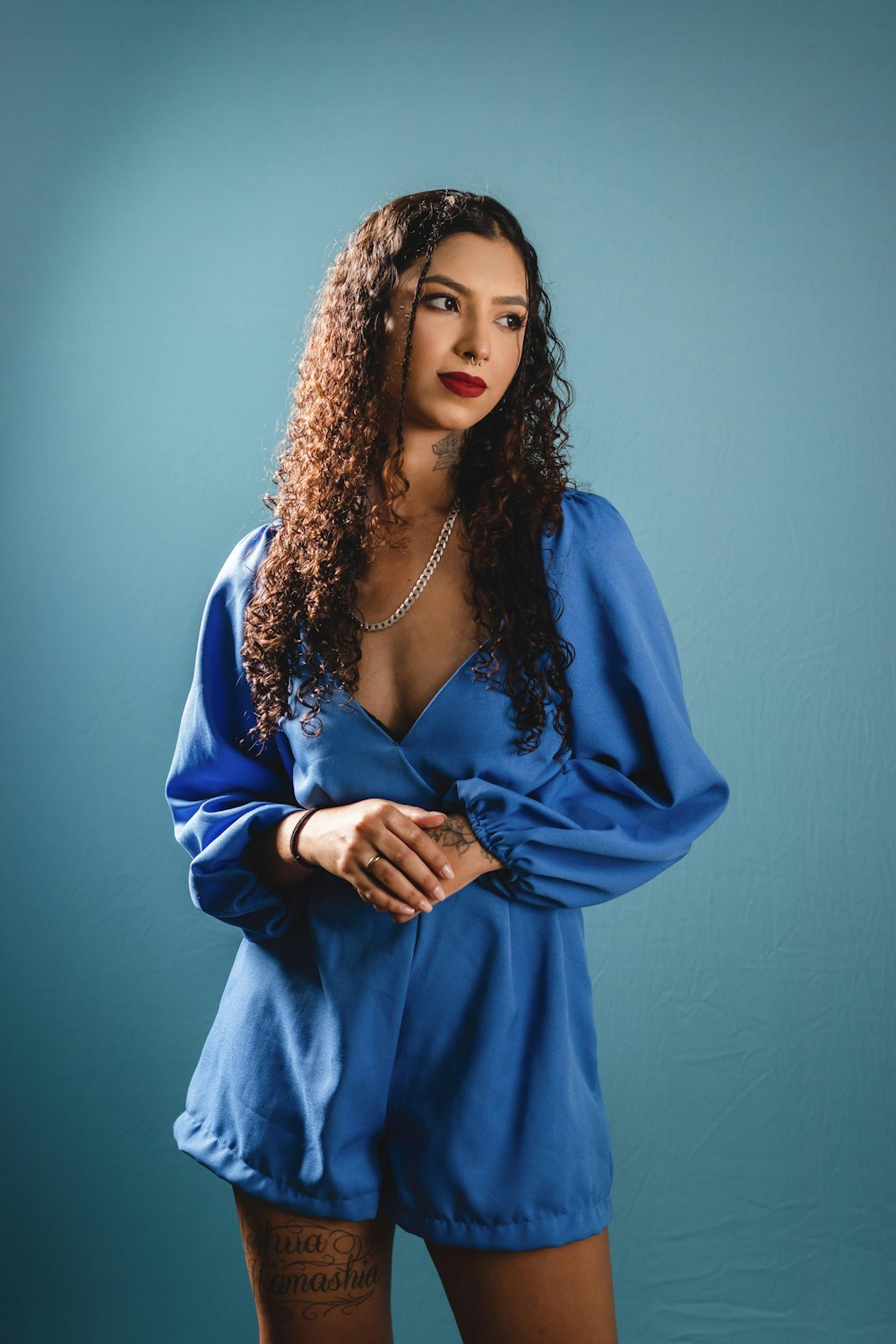 a woman in a blue dress posing for a picture