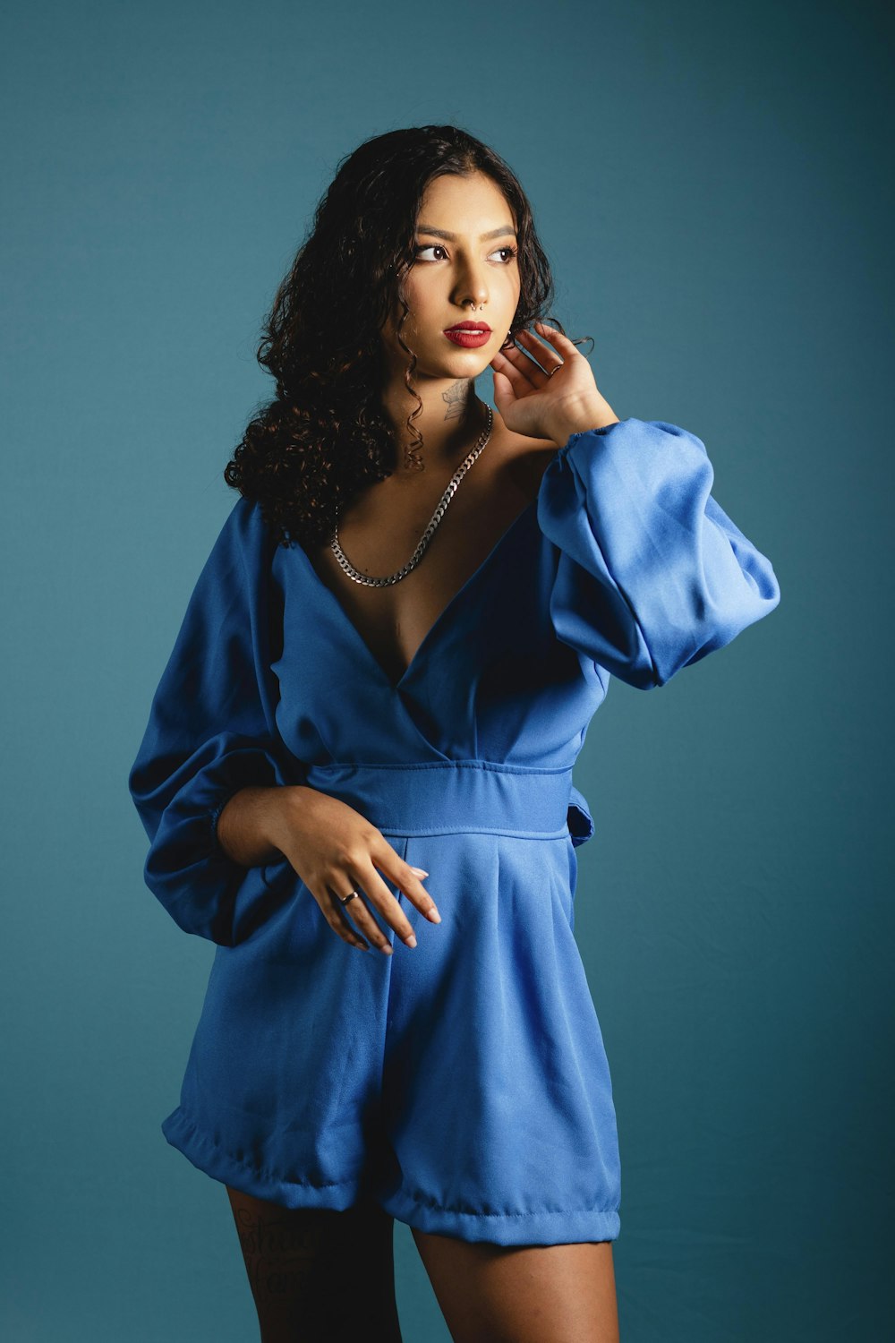 a woman in a blue dress posing for a picture