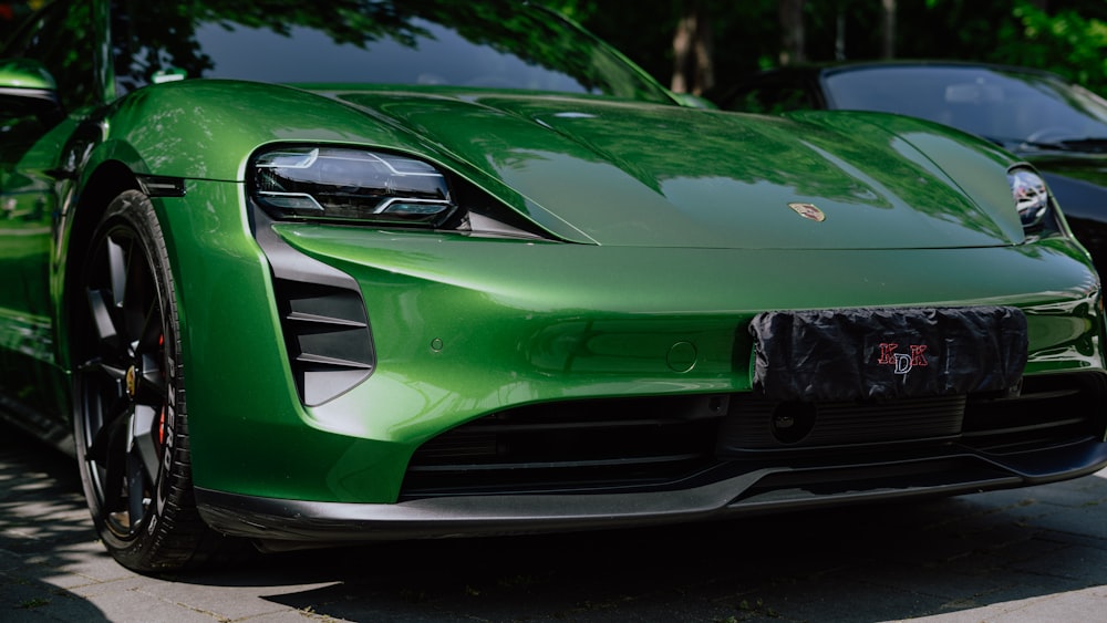 a green sports car parked on the side of the road