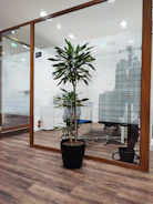 Modern office lobby adorned with lush artificial greenery and elegant pots