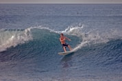 a man riding a wave on top of a surfboard