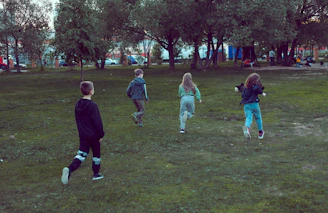 Smiling kids playing outdoors in a safe, vibrant community park.