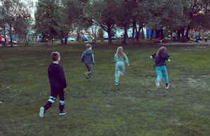 Children playing near a clean park area, symbolizing hope for a healthier future.