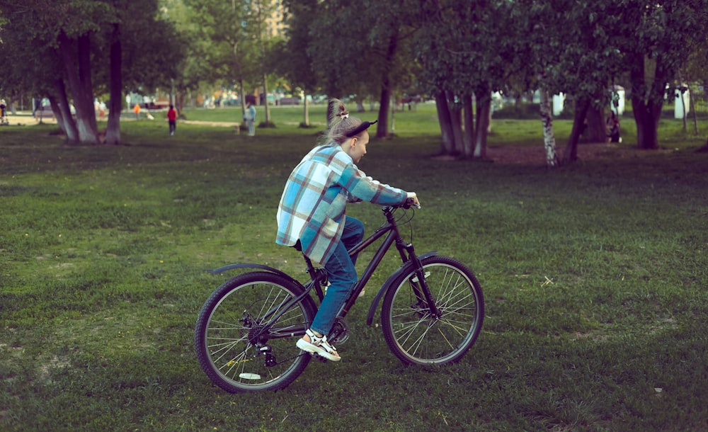 a man riding a bike in a park