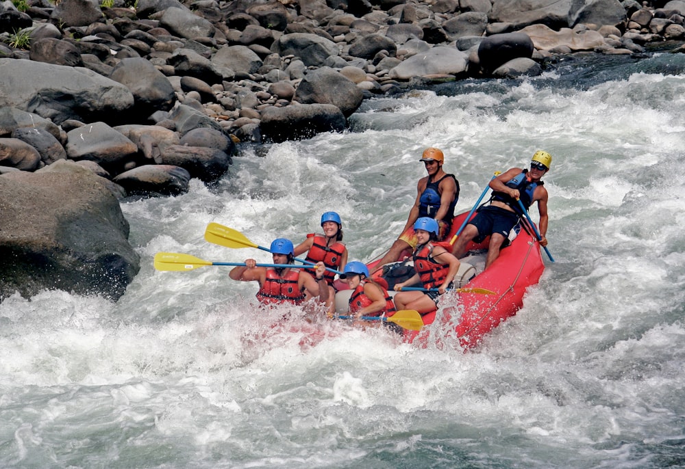 a group of people riding a raft down a river