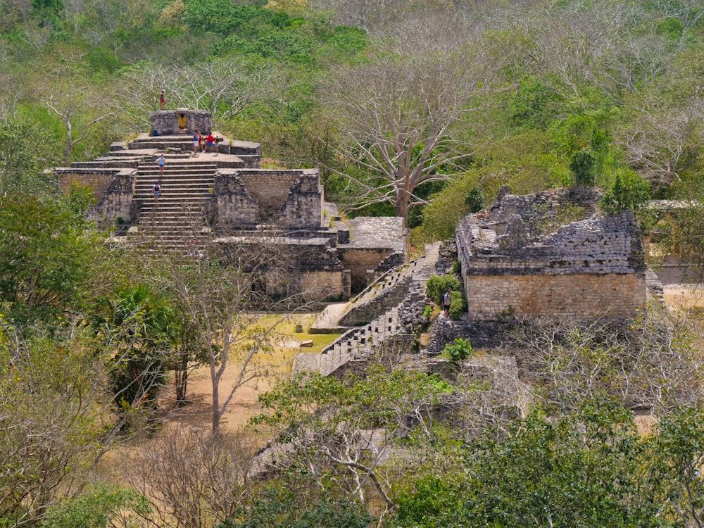 a group of people standing on top of a stone structure