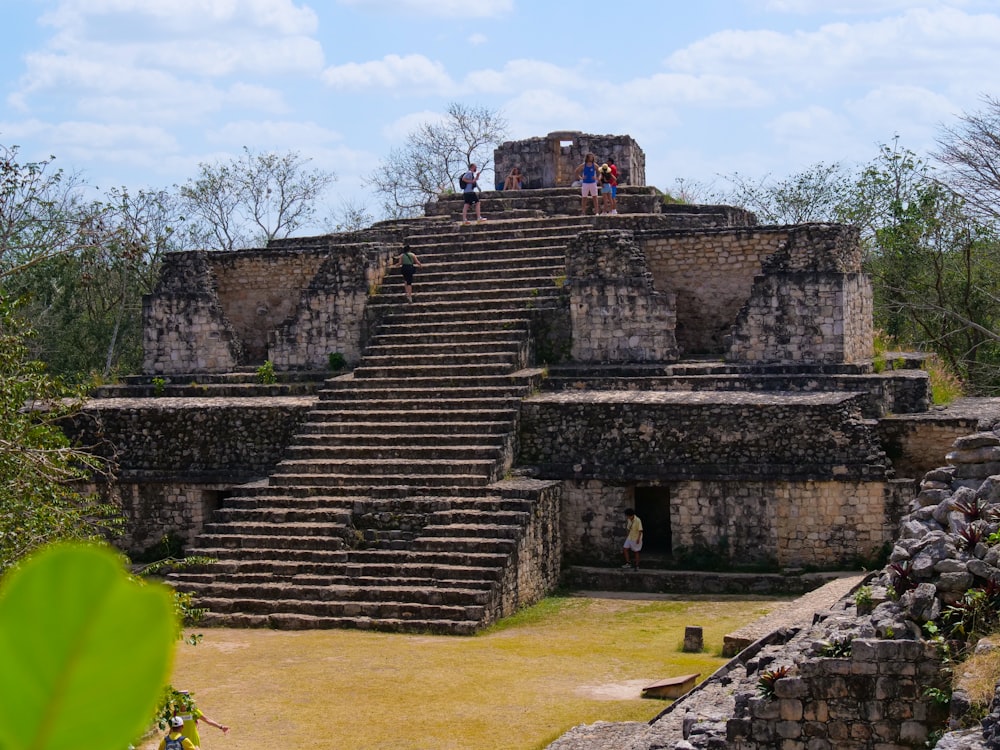 a group of people standing on top of a stone structure