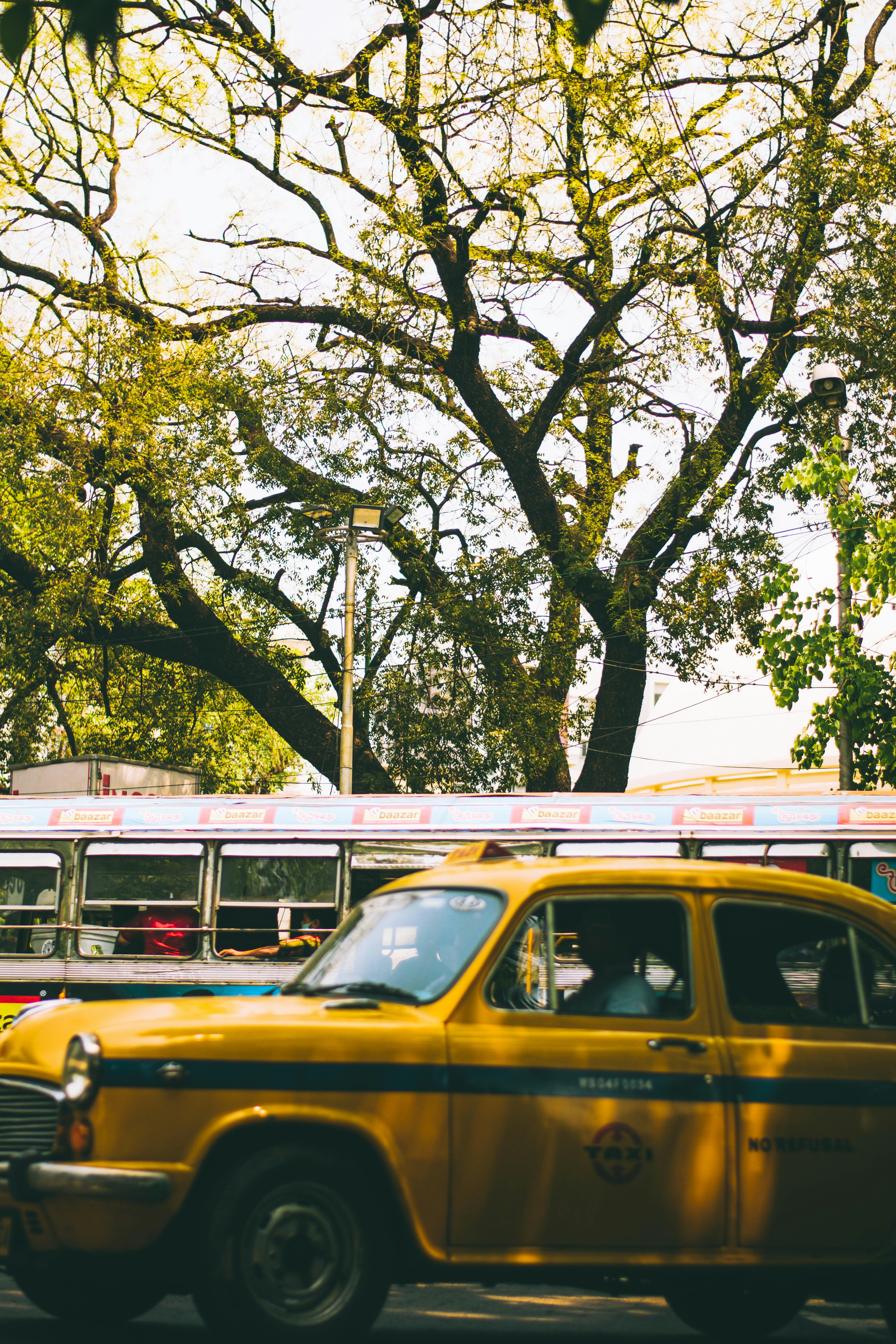 a yellow taxi cab driving down a street