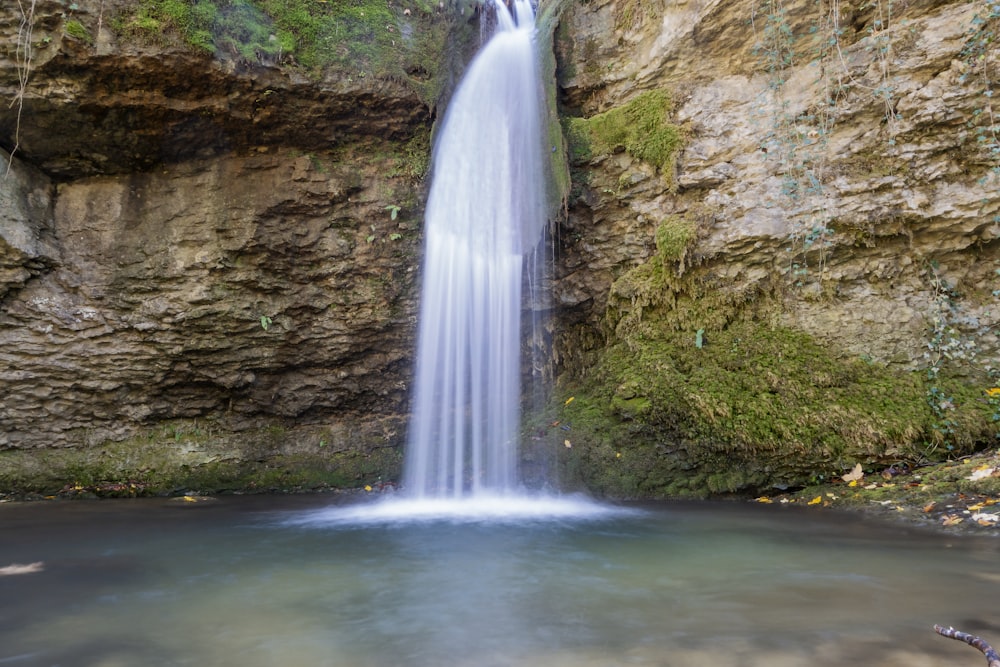 a large waterfall is in the middle of a body of water