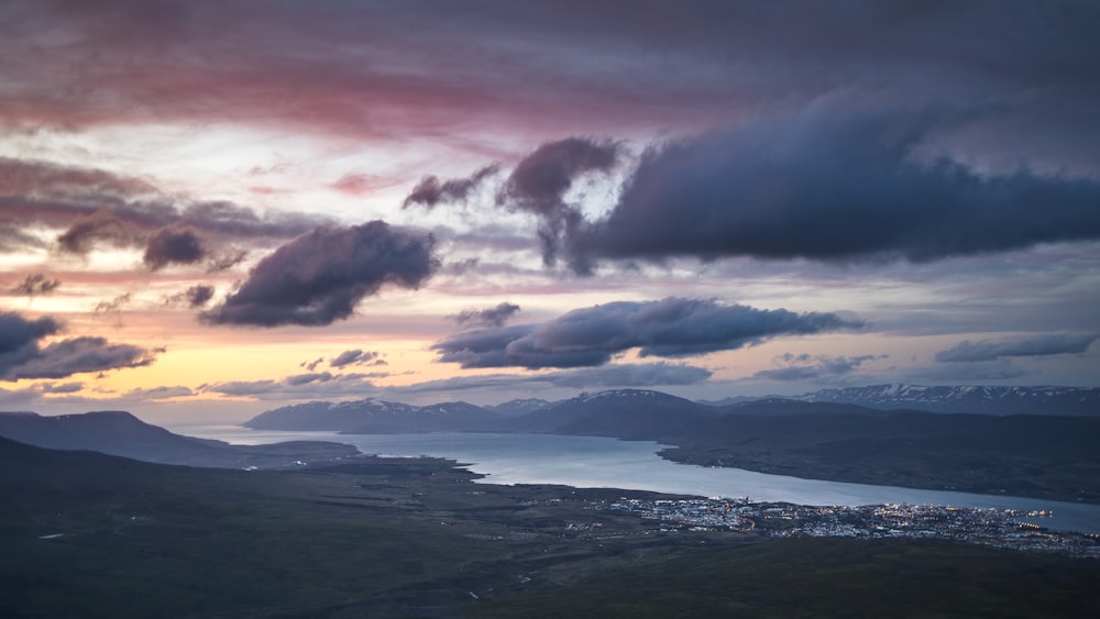 a view of a city and a body of water under a cloudy sky