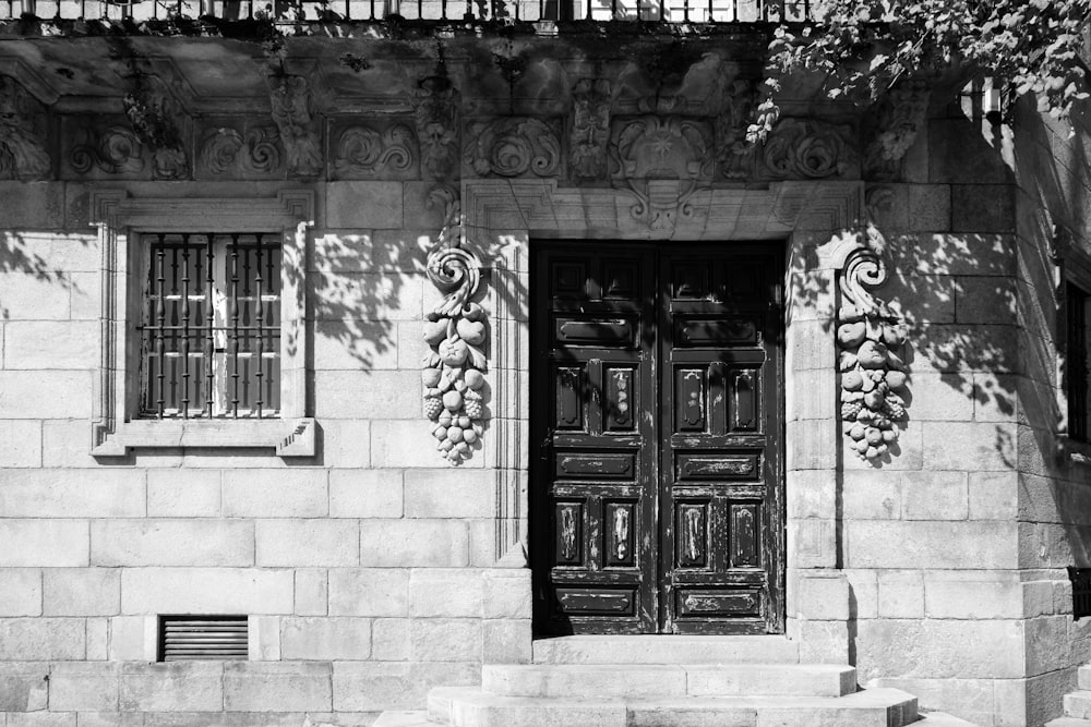 a black and white photo of a building with two doors