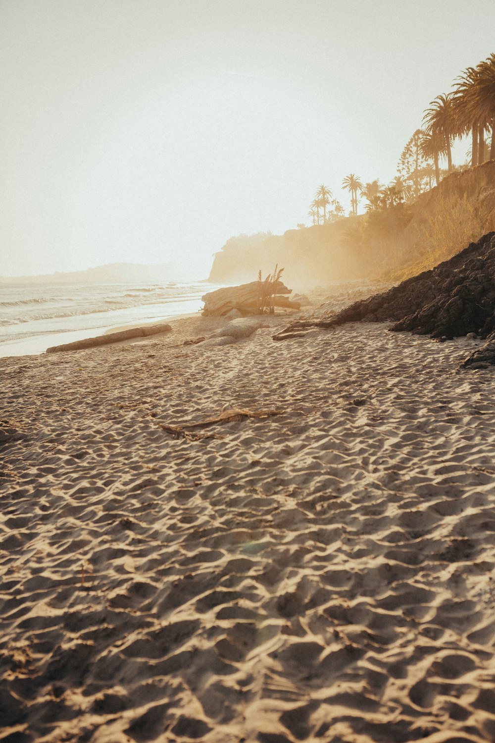 a sandy beach with a boat in the water