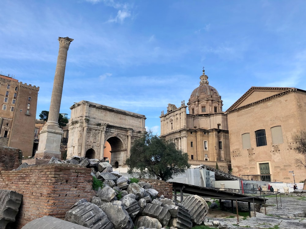 the ruins of a roman city with a large building in the background