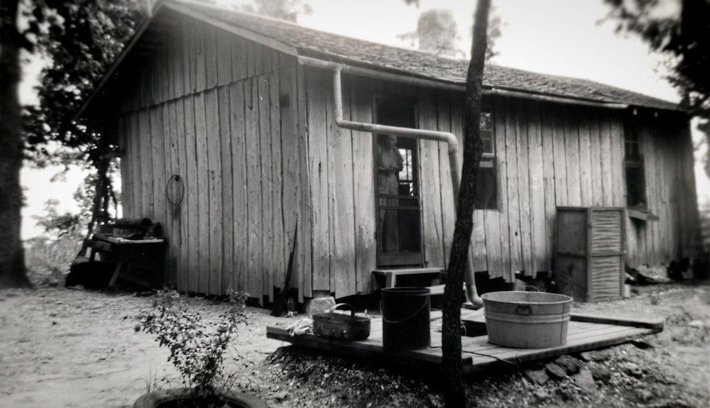 a black and white photo of a wooden house