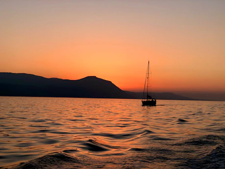 Sunset over Vassiliki bay with sailboats gently rocking on the water.