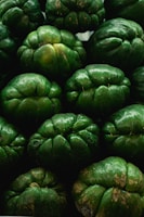 a pile of green fruit sitting next to each other