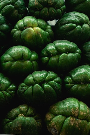 a pile of green fruit sitting next to each other